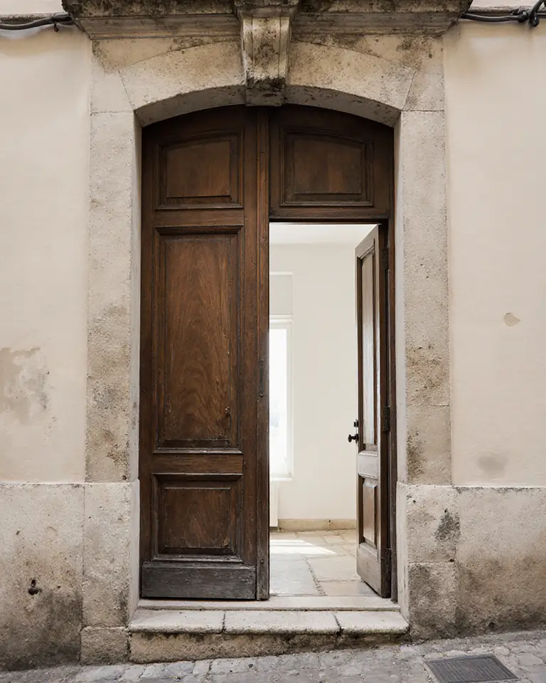 La porte en bois de l'atelier, entrouverte sur la rue des Apprêteurs
